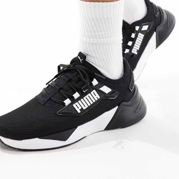 Puma Retaliate 3 trainers in black & white