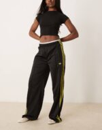 Firebird Loose track pants in black and light green - Image 3