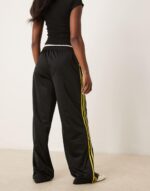 Firebird Loose track pants in black and light green - Image 2